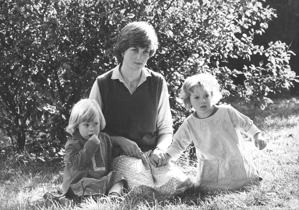 London, UK, UK. 9th Nov, 1980. Exact date unknown. Princess of Wales DIANA SPENCER sitting with two children on the grass yard of the kindergarden, Young England School in the Pimlico section of London, where she worked, at age nineteen. Â© KEYSTONE Pictures/ZUMAPRESS.com/Alamy Live News
