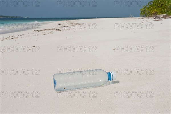 Plastic bottle washed up on a tropical beach in the Maldives.