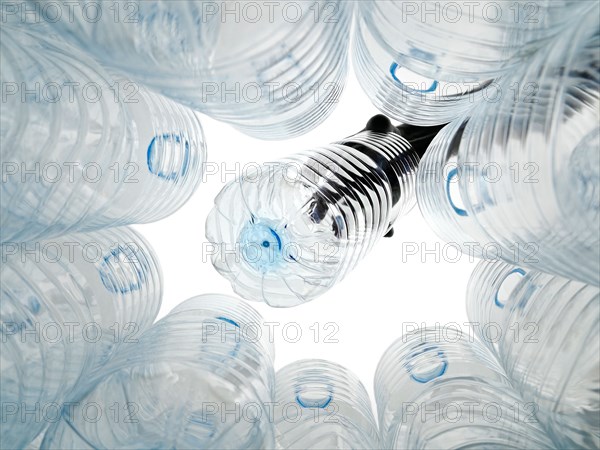 Plastic Bottle Being Put Into a Recycling Bin
