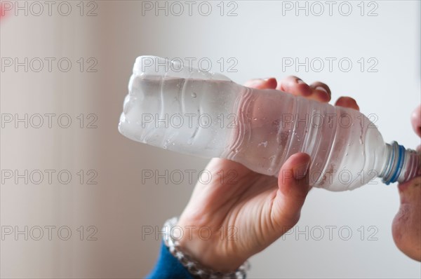 person drinking water from a plastic bottle-close-up