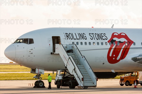 England, Manston airport. Rock and roll band, the Rolling stones Boeing 767, with lips and tongue logo on side in red, parked on apron with airstair.