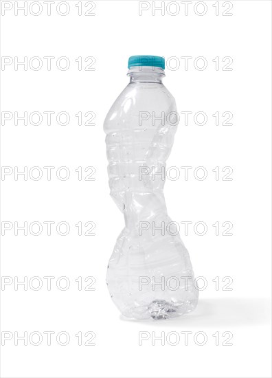 Studio shot of a crushed plastic water bottle