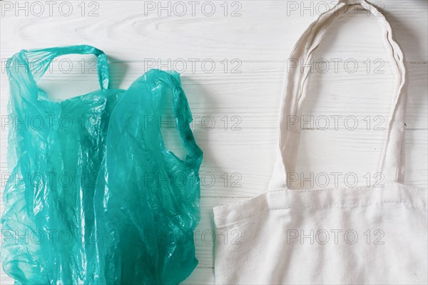 ban plastic. plastic bag with eco natural reusable tote bag for shopping, flat lay on rustic background. sustainable lifestyle concept. zero waste. pl