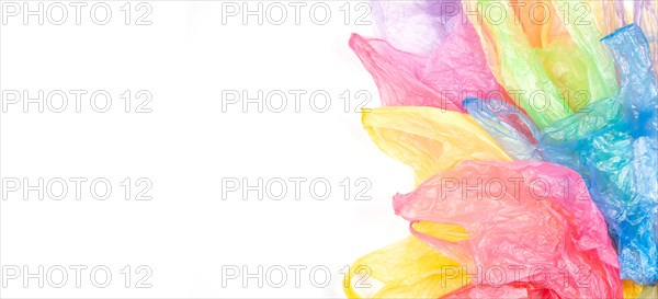Multicolored single use plastic shopping bags on white banner background