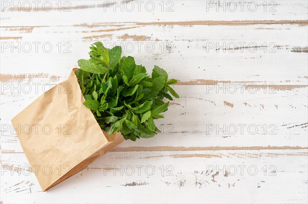 Top view of fresh mint in paper eco bag