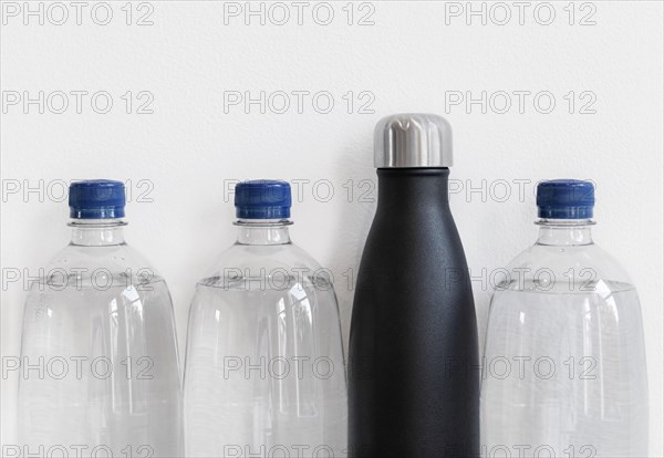Plastic bottles and reusable bottle made from stainless steel. Plastic free alternative concept, with copy space.