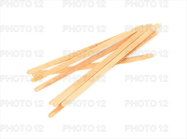 Wooden coffee stirrers on white background