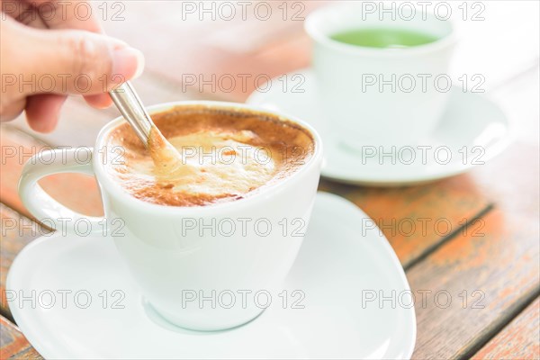 stir the coffee in cup and take to drink