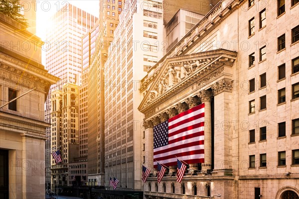 Famous Wall street and the building in USA, New York Stock Exchange with patriot flag