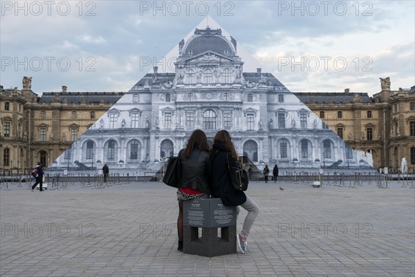 Louvre museum pyramid covered with thousands of paper sheets to make it disappear with an optical illusion.