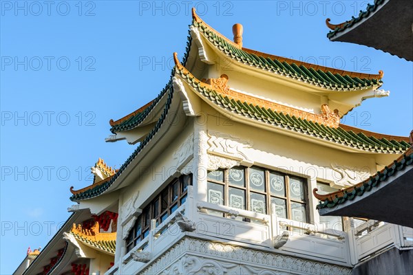 View of the chinese-inspired architecture of the Huatian Chinagora hotel complex with curved roof corners and traditional glazed roof tiles.