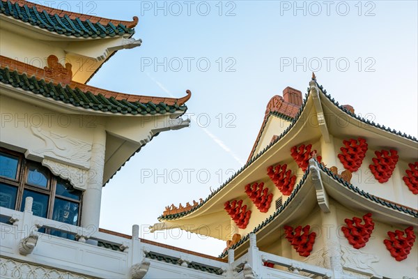 View of the chinese-inspired architecture of the Huatian Chinagora hotel complex with curved roof corners and traditional glazed roof tiles.
