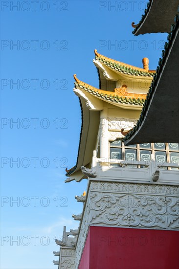 View of the chinese-inspired architecture of the Huatian Chinagora hotel complex with curved roof corners and traditional glazed roof tiles.