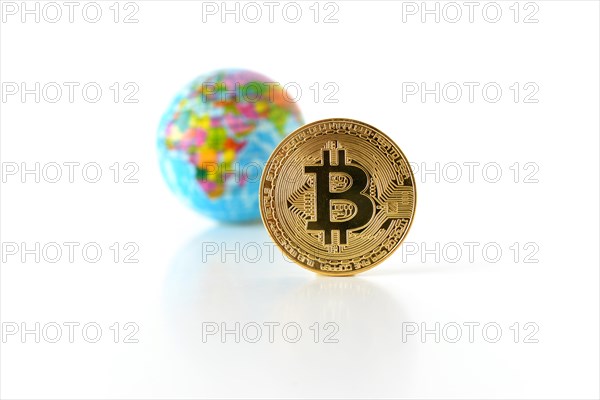 Bitcoin concept. World economy concept. New world currency. Golden coin bitcoin and globe.