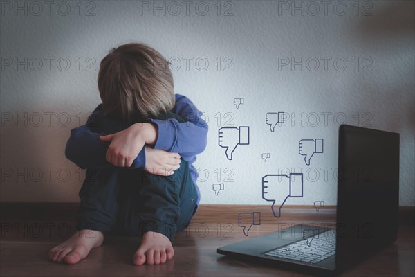 Cyber bullying concept - depressed boy with notepad and negative comments
