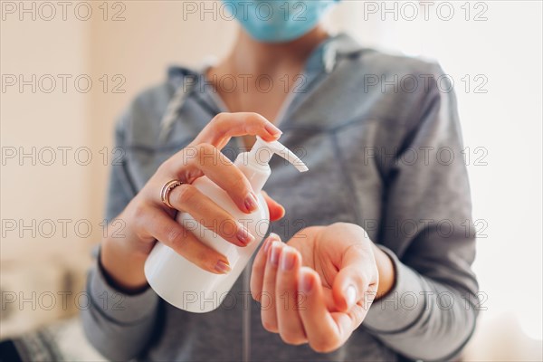Corona virus covid-19. Woman washes hands with alcohol gel antibacterial soap sanitizer wears medical mask. Healthcare