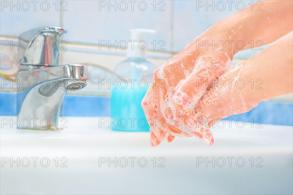 Washing hands with soap and water. Hands over sink with soap. Protective measures against coronavirus COVID-19 disease. Cleaning hands, washing hands