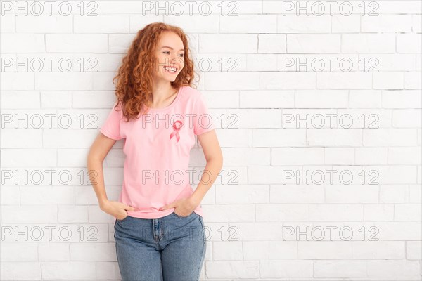 Girl In Breast Cancer T-Shirt Standing Over White Brick Wall