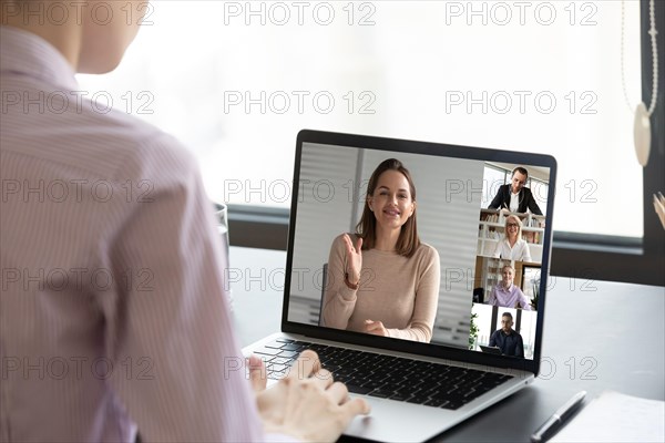 Female worker talk on video call with coworkers