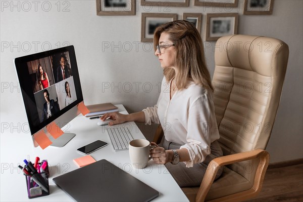 Beautiful woman work from home and have conversation with her subordinates