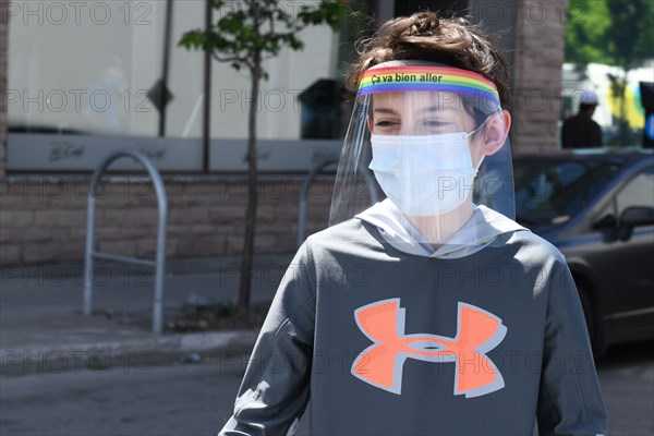 Boy wearing protective face masks and face shields during Covid-19 Pandemic in Montreal Canada (Model released)