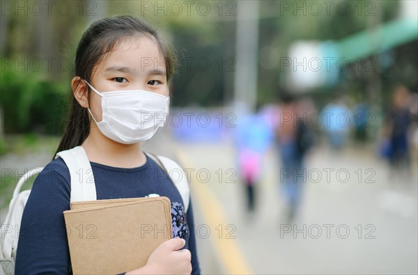 Back to school. asian child girl wearing face mask with backpack  going to school .Covid-19 coronavirus pandemic.New normal lifestyle.Education concep