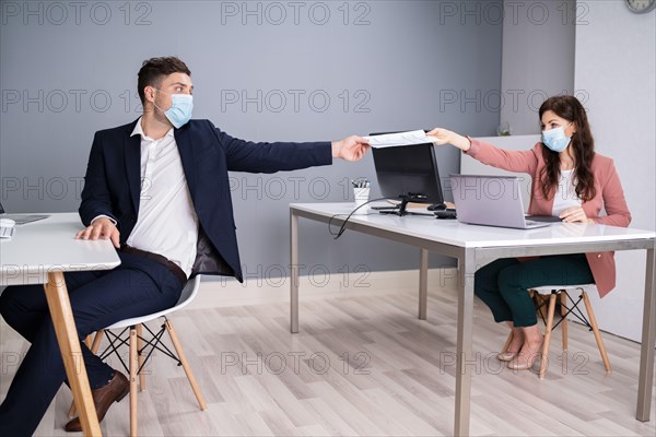 Working In Office Wearing Medical Face Masks Following Social Distancing