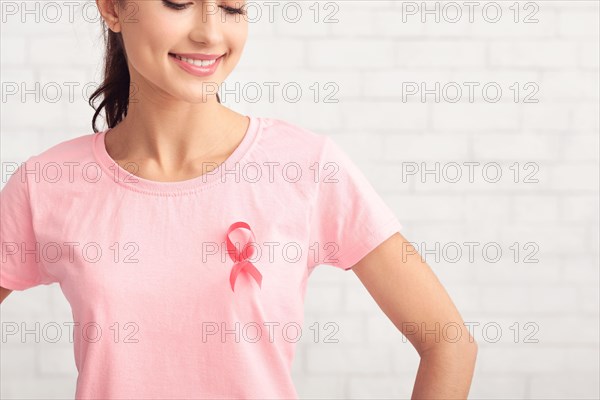 Girl Posing In T-Shirt With Cancer Ribbon On White Background