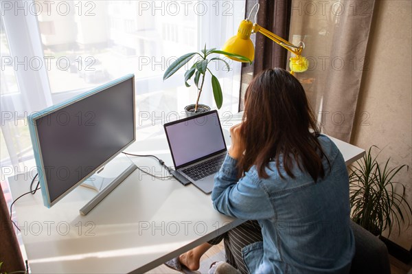 woman working on laptop at home office