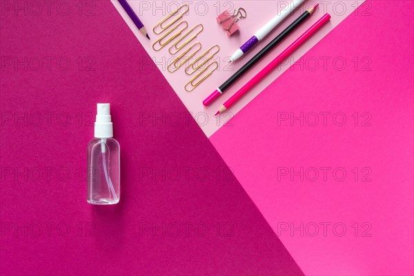 Top view of school stationery and sanitizer and on a multicolored background. Back to school 2020 flat lay and Copy space