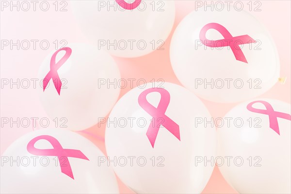 White latex balloos with pink reibbons.