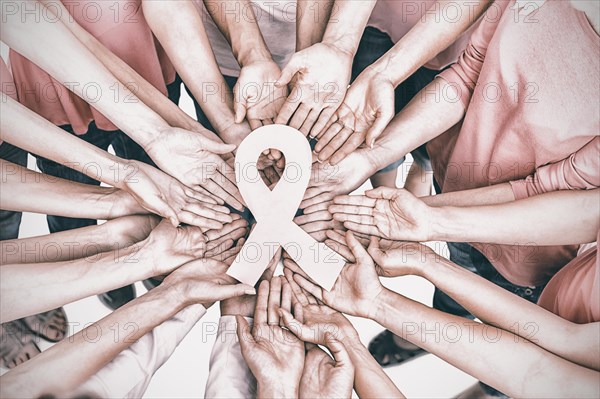 Hands joined in circle holding breast cancer struggle symbol on white background