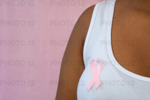 healthcare and medicine concept  woman in blank tshirt with pink breast cancer awareness ribbon