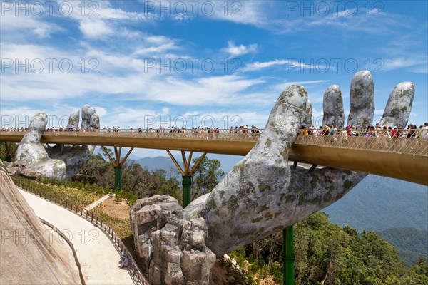 Bà Nà Hills, Vietnam - August 22 2018: The Golden Bridge is located in the Truong Son Mountains, which ar part of the Annamite Range.