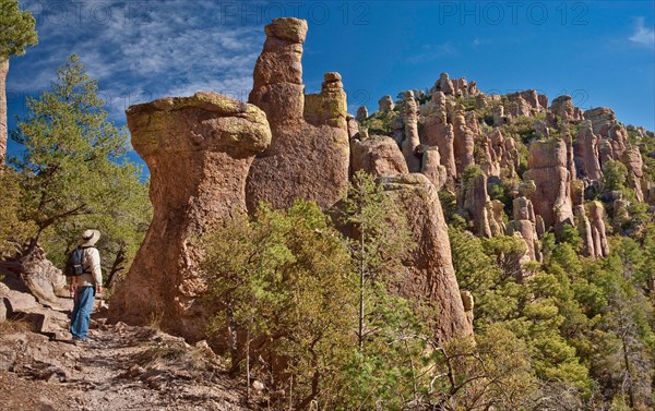 Hiker at rock pinnacles on Hailstone Trail in Chiricahua National Monument, Arizona, USA