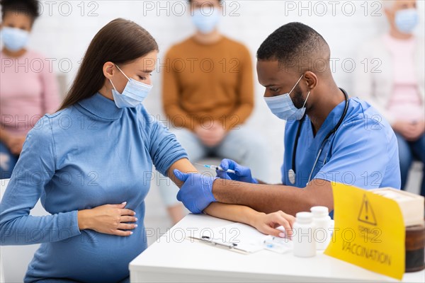 Pregnant Lady In Mask Getting Vaccinated Against Coronavirus In Hospital