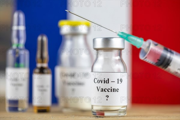 France Flag and bottle with vaccine and syringe, Coronavirus, Covid-19, Medicine, science and healthcare concept