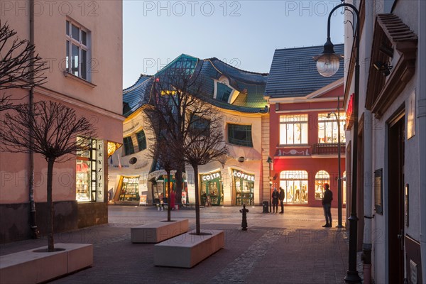 Evening at Krzywy Domek (Crooked House) in Sopot, Poland.