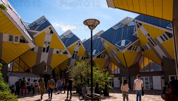 ROTTERDAM, NETHERLANDS - AUGUST 13, 2017 : Group of tourists in the yard of Cube houses or Kubuswoningen in Dutch are a set of innovative houses desig