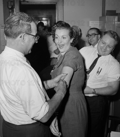 Woman at a health clinic gets a flu shot in Chicago, ca. 1960.