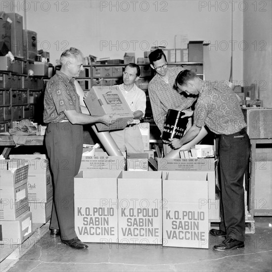 Four men unpack the Sabin polio vaccine for a publicity photo in California, ca. 1962.