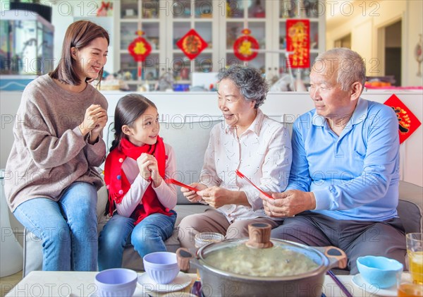 happy asian family celebrating chinese new year at home