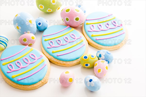 Easter cookies in shape of egg decorated with blue icing.