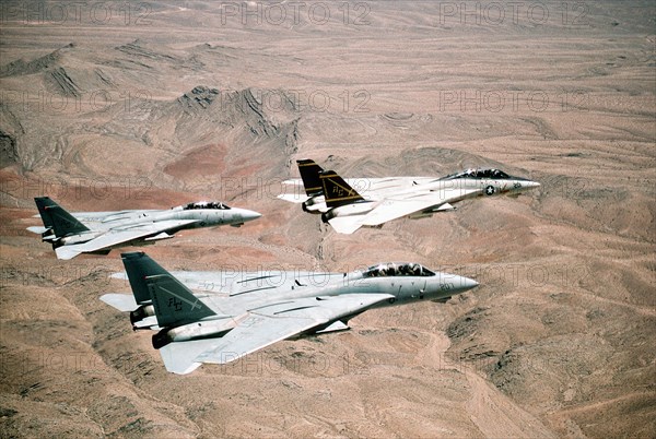 A US Navy Fighter Squadron of F-14A Tomcat fighter aircraft fly in formation over the desert during Operation Desert Storm February 7, 1991 in Kuwait.