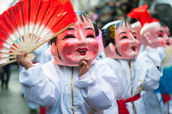 Paris, France - Feb 2, 2014: Chinese performers wearing a mask in traditional costume at the chinese lunar new year parade