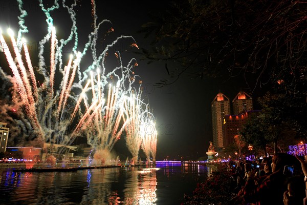 Kaohsiung, Taiwan. People watching the fireworks for the chinese new year at the Love River of Kaohsiung. The Chinese New Year is an important Chinese festival celebrated at the turn of the Chinese calendar. In China, it is also known as the Spring Festival, the literal translation of the modern Chinese name.