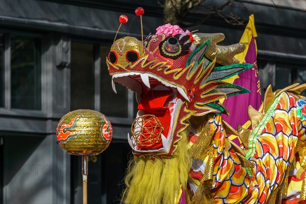 VANCOUVER, CANADA - February 18, 2018: People playing dragon dance for Chinese New Year in Chinatown.