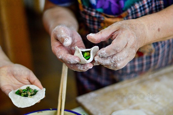 Chinese Family Make Dumplings, traditional food popular for Chinese New Year festival.