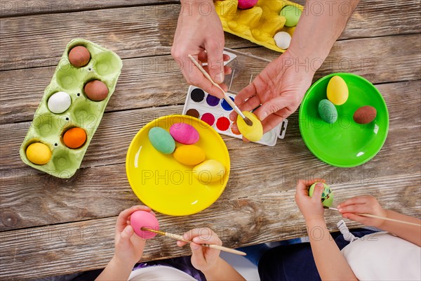 Easter. A happy family will paint eggs and get ready for Easter. Top view of the table with paints and eggs.