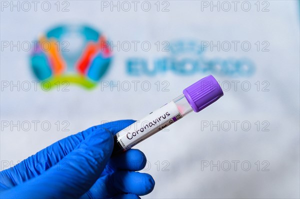 MADRID, SPAIN, MARCH. 8. 2020: Coronavirus positive blood test and logo of football tournament UEFA Euro 2020